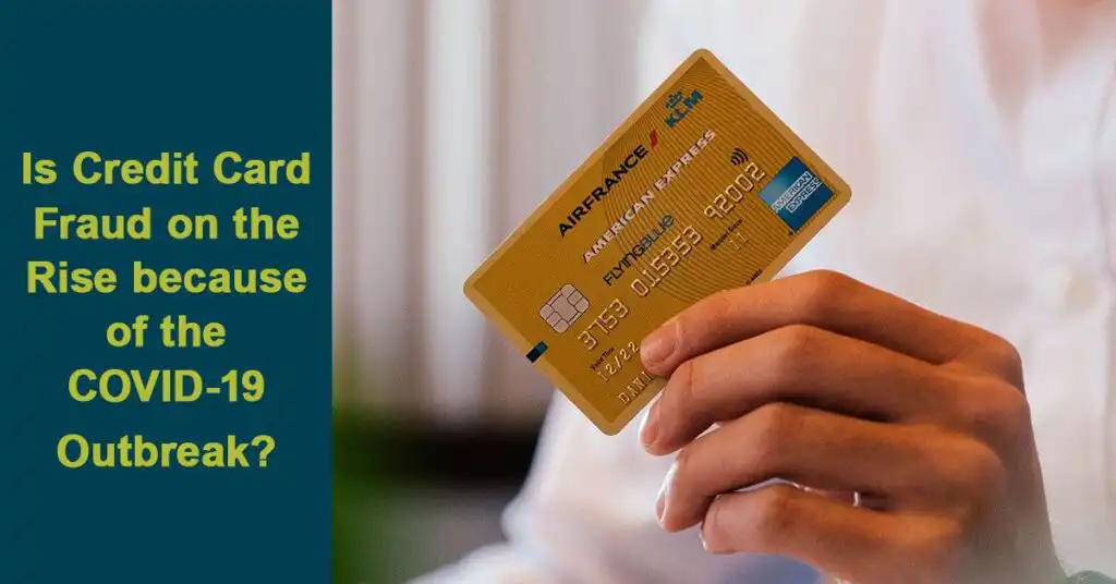man holding up credit card