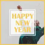 Golden text "Happy New Year" rests on top of image of woman in green jacket throwing confetti.