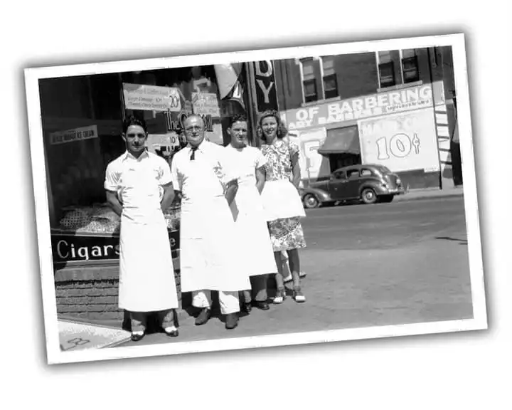 Four workers standing outside of Old Mill Tasty Shop