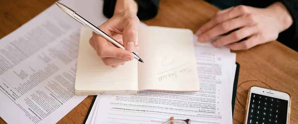 Woman writing stuff in book