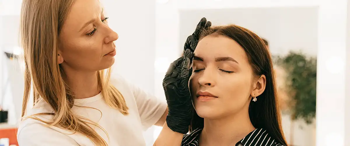 Woman doing another woman's makeup