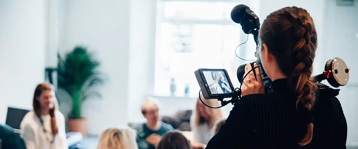 Woman video taping a talk