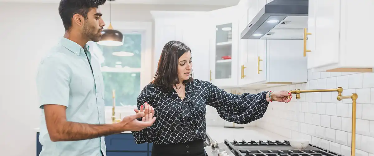 Woman showing a potential renter around a kitchen