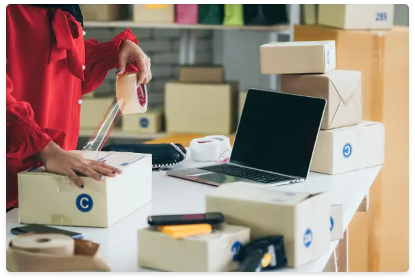 Packaging employee taping together box