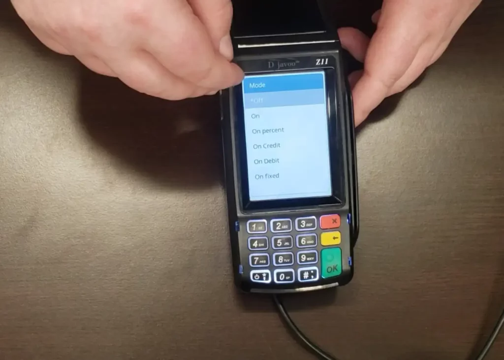 Man holding Dejavoo Z11 credit card machine. Once choosing “tip” and “inline”, retailer merchants are able to select how they’d like tip prompts to be displayed – on, a percentage, only on credit/debit, or fixed.