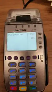 Verifone terminal on table displaying two options; TCPIP or SSL