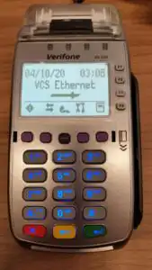 Verifone terminal on table displaying VCS Ethernet